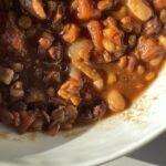 This slow cooker lentil and bean chili is an easy and delicious crockpot dump meal that the whole family will enjoy. It only requires 10 minutes of hands on time and is perfect for those week nights where you only have a few minutes tops to devote to dinner. | just the recipes, please