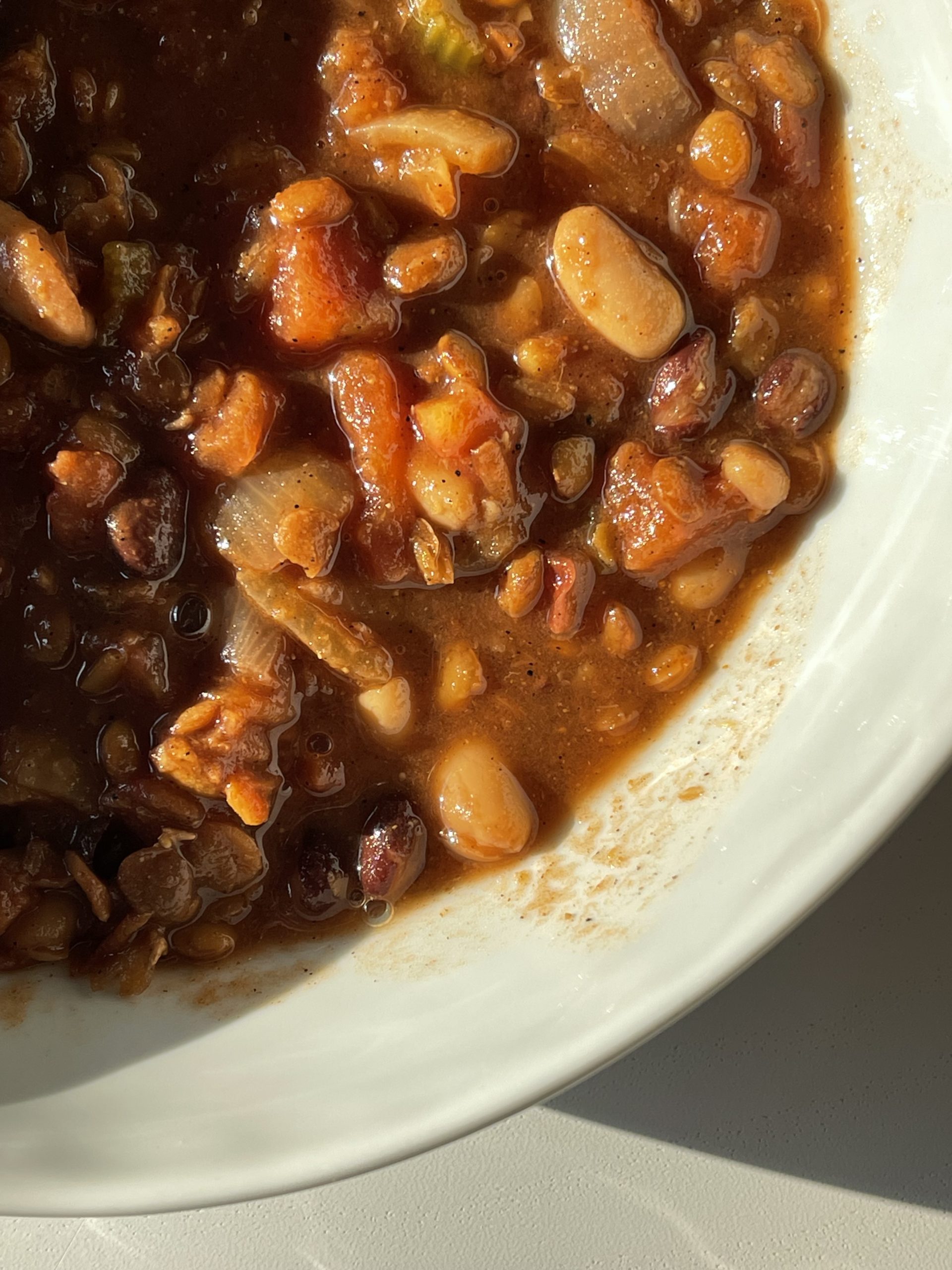 This slow cooker lentil and bean chili is an easy and delicious crockpot dump meal that the whole family will enjoy. It only requires 10 minutes of hands on time and is perfect for those week nights where you only have a few minutes tops to devote to dinner. | just the recipes, please
